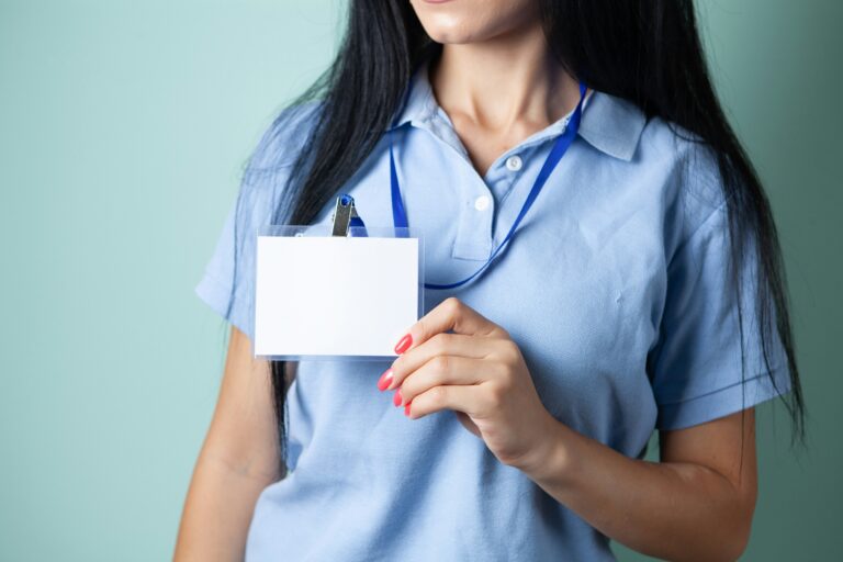 A woman holding a blank credential