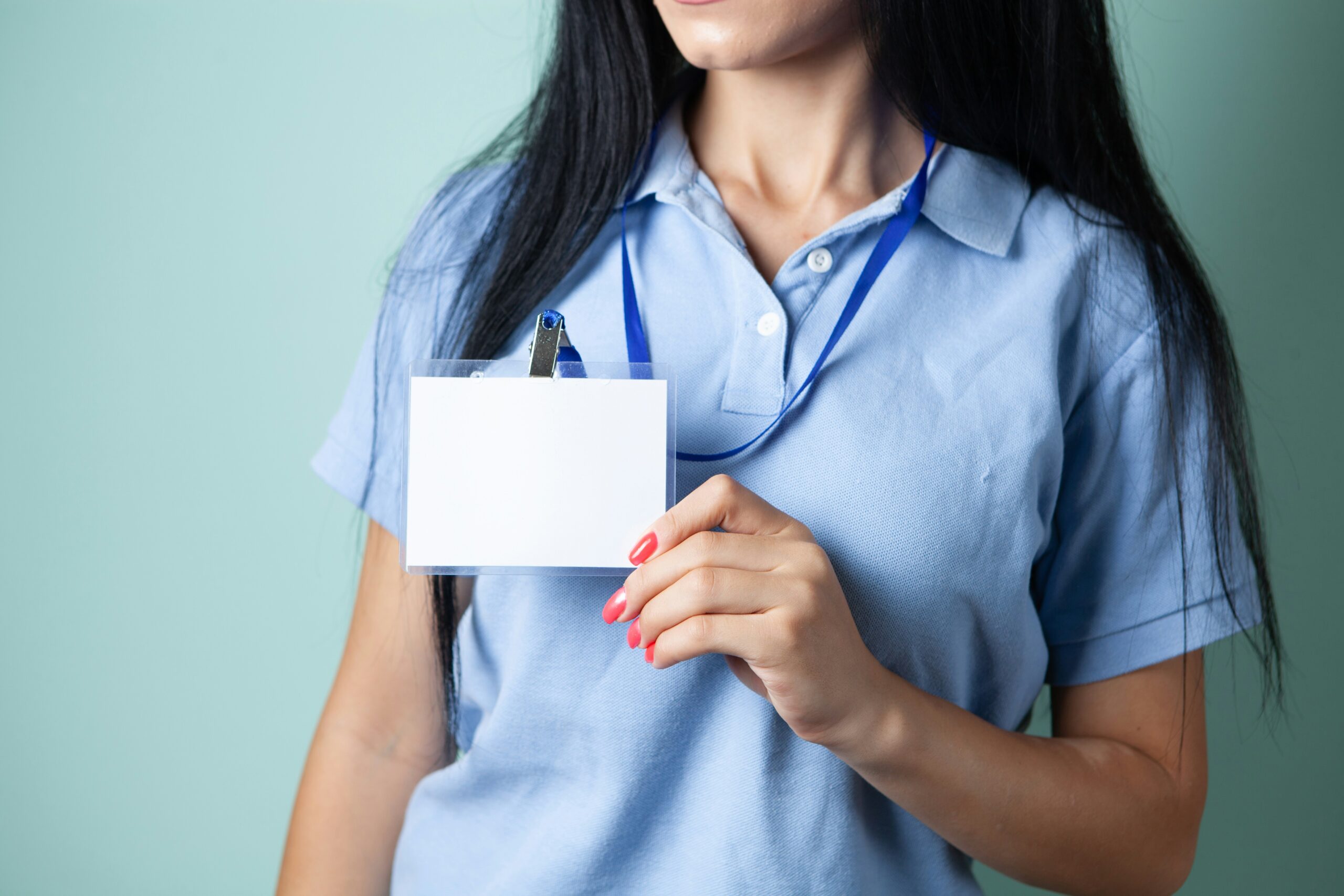 A woman holding a blank credential